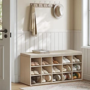 A wooden shoe storage bench with cubbies holds multiple pairs of shoes, and a wall-mounted coat rack with hooks has hanging items like a hat and scarf.