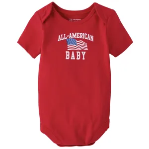 Red baby onesie featuring the phrase \“All-American Baby\“ with an American flag graphic.