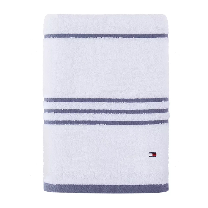 White bath towel with horizontal grey stripes and a small red and navy blue logo on the lower corner.