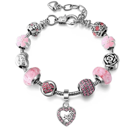A charm bracelet with pink and silver beads featuring floral designs, a rose motif, and a heart-shaped charm encrusted with pink crystals.