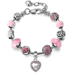 A charm bracelet with pink and silver beads featuring floral designs, a rose motif, and a heart-shaped charm encrusted with pink crystals.