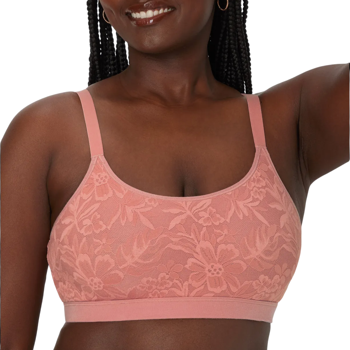 A woman wearing a pink lace bra with floral patterns is shown from the shoulders to the waist.