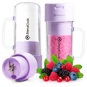 A compact, purple portable blender with a detachable lid and handle, designed for mixing smoothies, as shown with a pink blended drink next to a mix of berries. The design includes visible blades for blending.