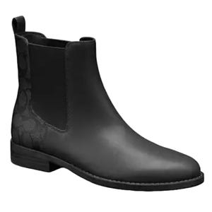 Black Coach Chelsea boots with a smooth finish, featuring elastic side panels and a subtle pattern on the side.