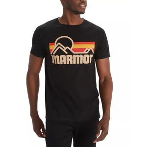 Black T-shirt featuring the Marmot logo with a retro mountain and sunset design in red, orange, and beige hues.