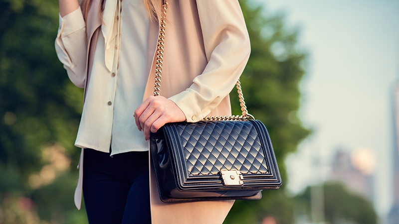 woman with black quilted handbag