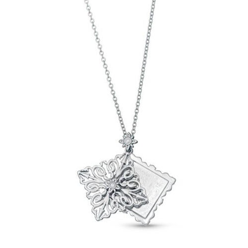 A silver necklace featuring a filigree snowflake pendant and a rectangular pendant with scalloped edges, both adorned with small gemstones.