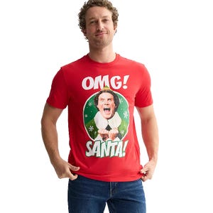 A red T-shirt featuring a character from the movie \“Elf\“ with the text \“OMG! SANTA!\“ The design includes a festive image of a character expressing excitement about Santa.