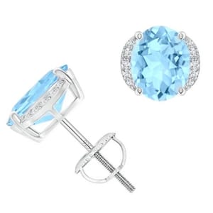 A pair of earrings featuring oval-cut lab-created blue topaz stones encircled by smaller clear stones in a silver-tone setting.