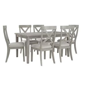 The 7-piece Signature Design by Ashley Dining Set features a rectangular gray table with a wood finish and six matching chairs with X-shaped backrests and upholstered seats.