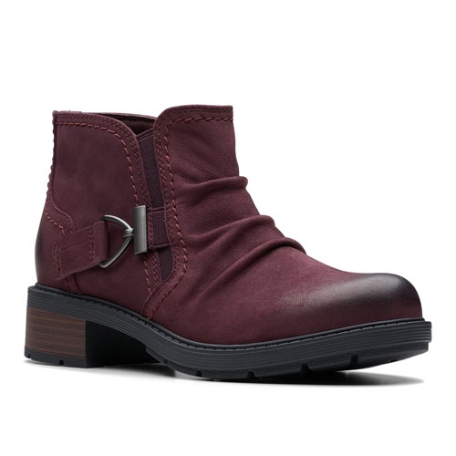 A maroon ankle boot with a ruched design, buckle detail on the side, and a low stacked heel.