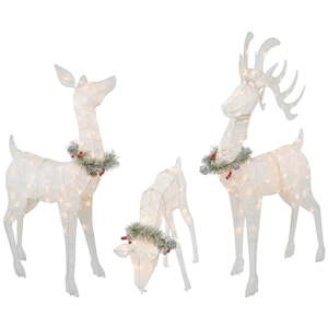 Three illuminated deer decorations adorned with pine and berry garlands.