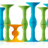Colorful suction cup toys labeled \“PopDarts,\“ featuring green, blue, and one distinct orange design marked \“Pro.\“