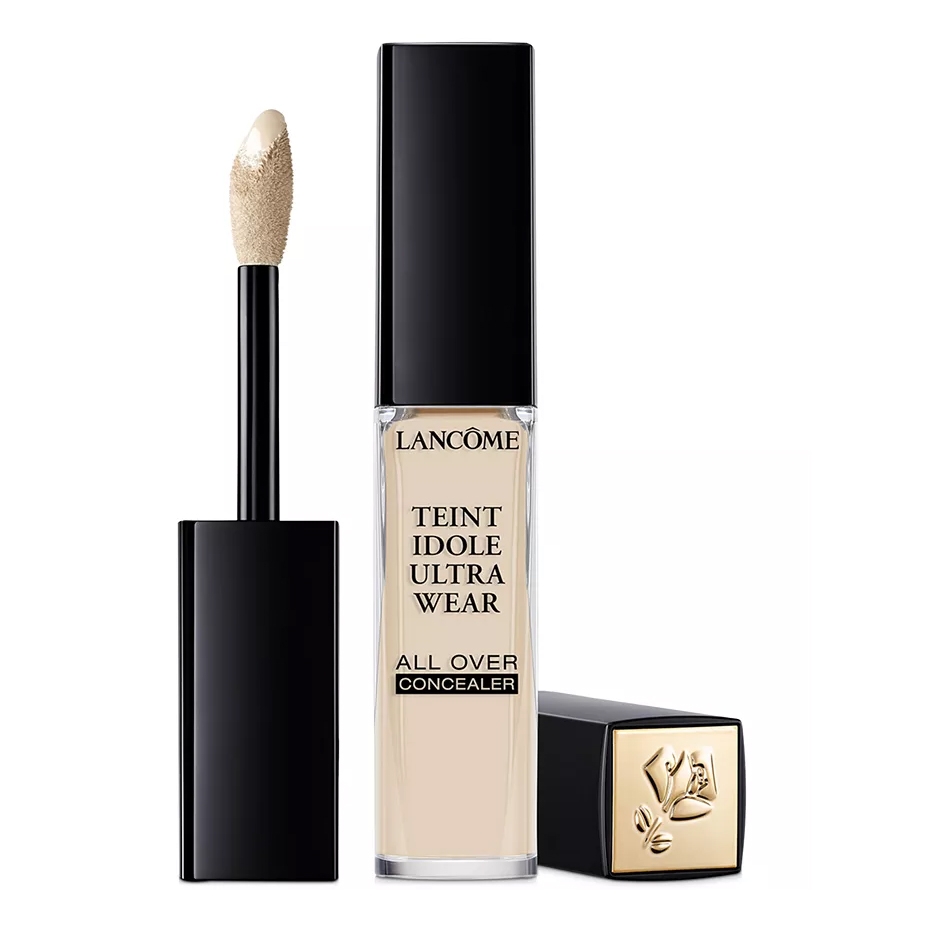 Lancôme Teint Idole Ultra Wear All Over Concealer features a creamy formula with a doe-foot applicator, designed for long-lasting coverage. The packaging is sleek with a black cap and a gold logo.
