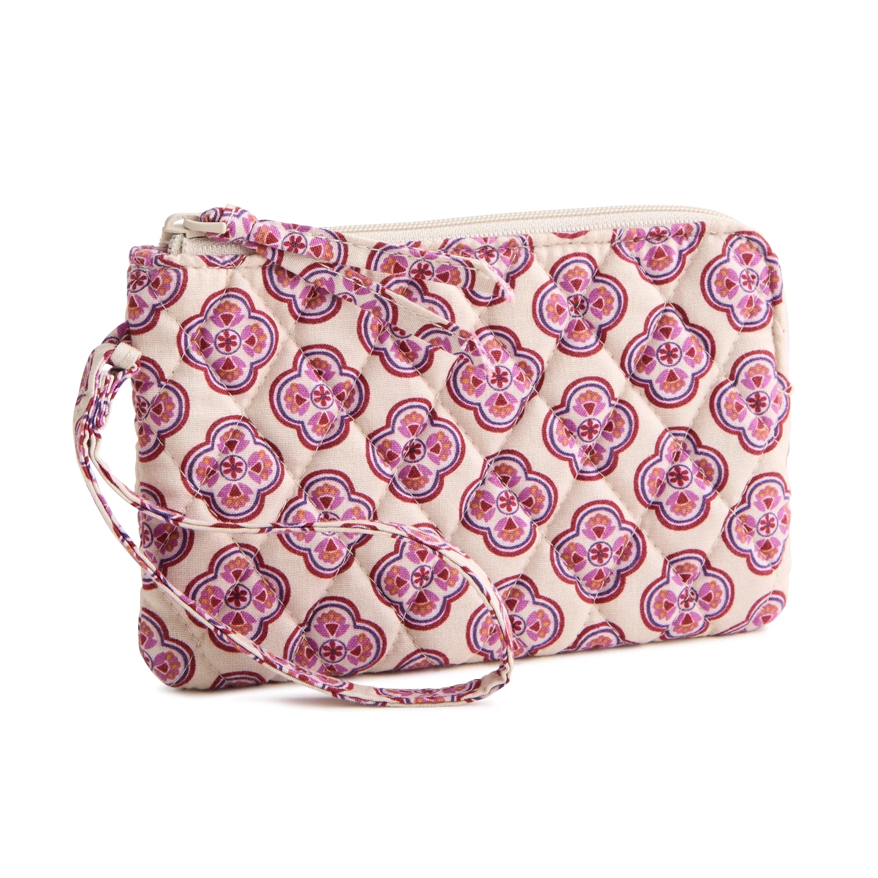 A quilted wristlet with a geometric floral pattern in pinks and purples on a beige background. It features a zipper closure and a matching strap.
