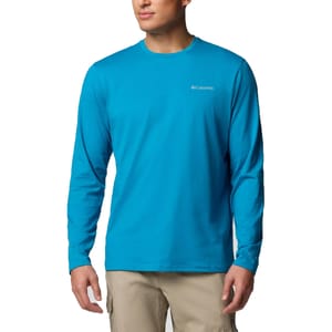 A person wearing a bright blue long-sleeve Columbia shirt with the logo on the chest, paired with beige cargo pants.