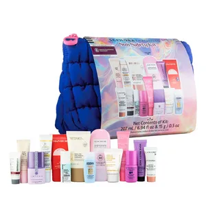 A collection of skincare and sun protection products displayed with a blue quilted bag, including various tubes and bottles from multiple brands, specifically sunscreen items.