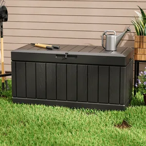 A black outdoor storage bench with a shovel and trowel on top, next to a metal watering can.