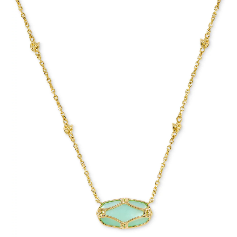 A gold chain necklace featuring a green oval pendant with intricate gold detailing.