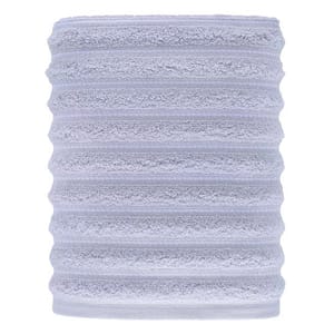 A light gray, ribbed cylindrical object made of plush, textured material, likely a microfiber towel or sleeve.