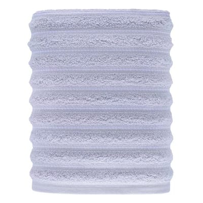 A light gray, ribbed cylindrical object made of plush, textured material, likely a microfiber towel or sleeve.