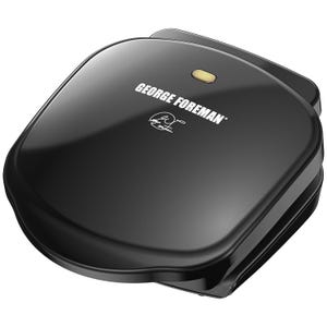 George Foreman Electric Indoor Grill is a compact, black appliance designed for grilling indoors, featuring a sloped design to reduce fat and a nonstick coating for easy cleaning.