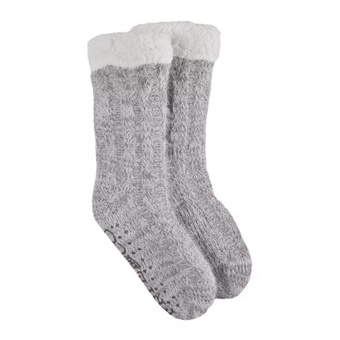 Frye and Co. Women's Slipper Socks are gray with white fluffy cuffs, featuring a cable-knit design and rubber grips on the soles for slip resistance.