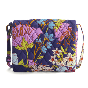 Quilted shoulder bag with a vibrant floral pattern featuring purple, pink, blue, and white flowers on a dark background.