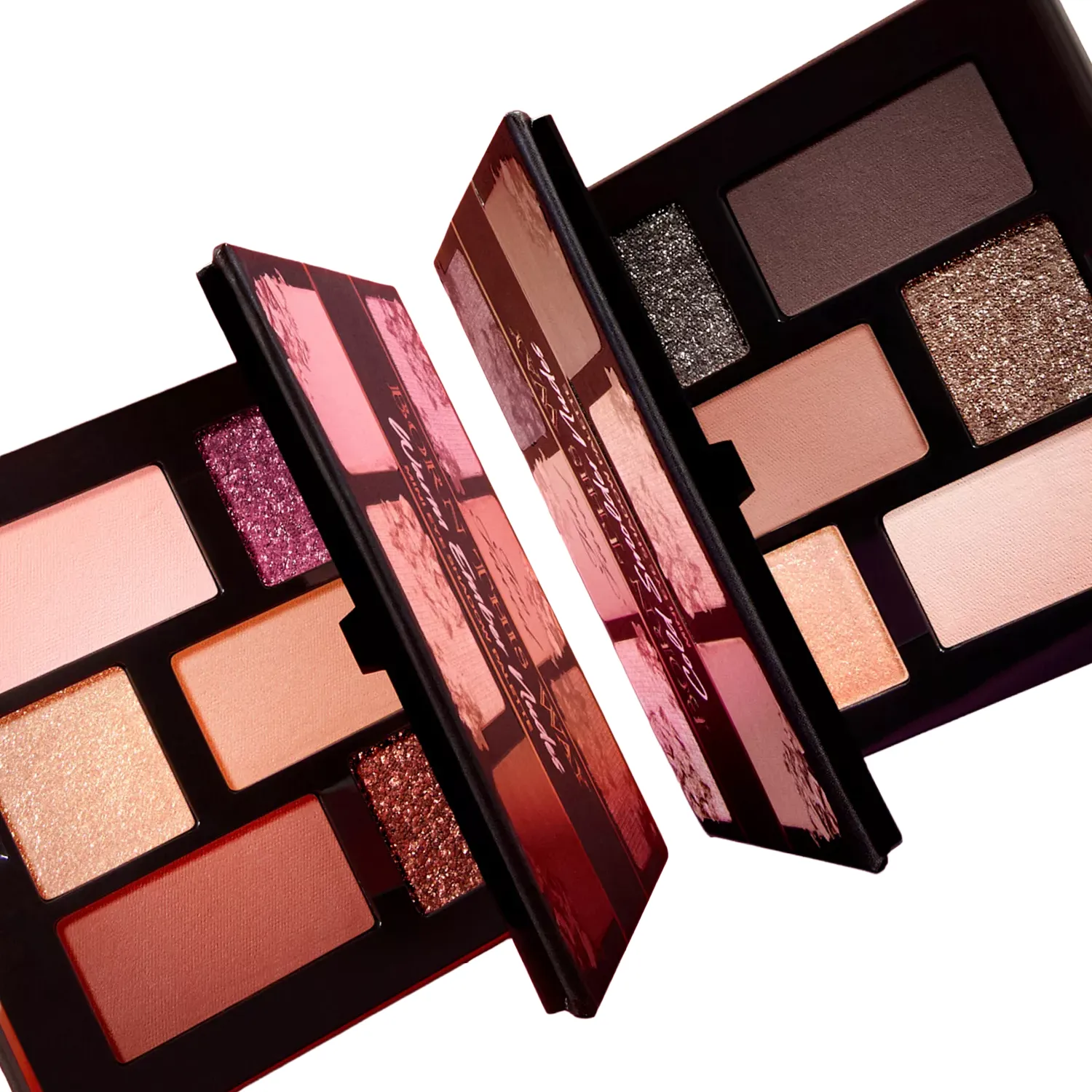 Two open eyeshadow palettes are displayed, each containing a variety of shades including shimmering and matte finishes in warm and neutral tones.