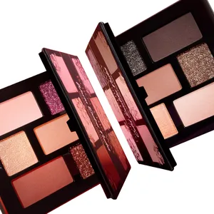 Two open eyeshadow palettes are displayed, each containing a variety of shades including shimmering and matte finishes in warm and neutral tones.