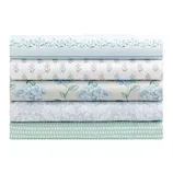 Stack of five folded fabrics with various floral and geometric patterns in blue, green, and white tones.