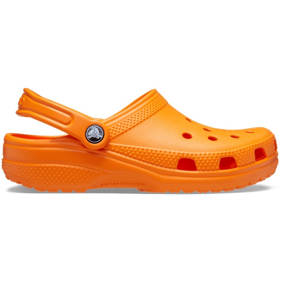 An orange Crocs Classic Clog featuring a perforated design for breathability, with an adjustable heel strap for a secure fit.
