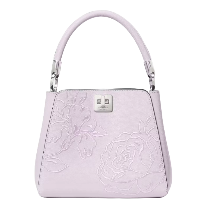 Lavender handbag with floral embossed design, featuring a metal clasp and a structured top handle.