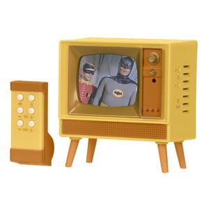 A retro-style miniature TV with a remote, displaying an image of two costumed characters. The TV is yellow with a brown speaker area and sits on four legs, designed to resemble an old-fashioned television set.