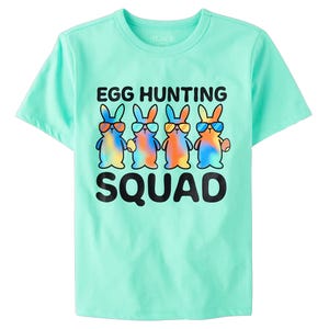 Mint green T-shirt featuring colorful bunnies wearing sunglasses, holding eggs, with the text \“Egg Hunting Squad.\“