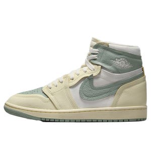 A pair of Air Jordan 1 Retro High OG sneakers in light green and cream with a white panel, featuring a Nike swoosh and the signature Air Jordan wings logo on the collar.