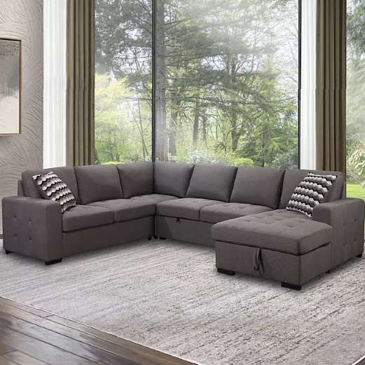 L-shaped sectional sofa with a chaise and matching throw pillows, set on a grey rug.