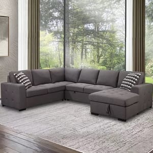 L-shaped sectional sofa with a chaise and matching throw pillows, set on a grey rug.