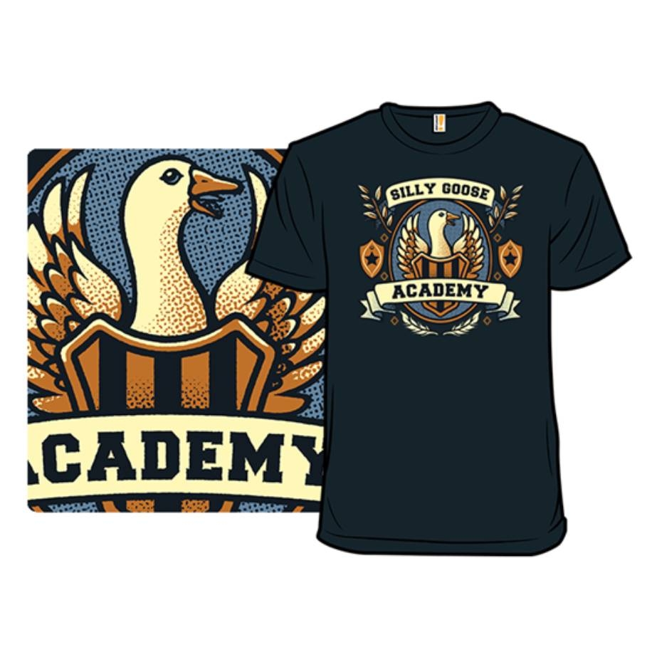 A navy blue T-shirt features a design with a goose and the text \“Silly Goose Academy\“ in a crest-like emblem, surrounded by decorative leaves and shields.
