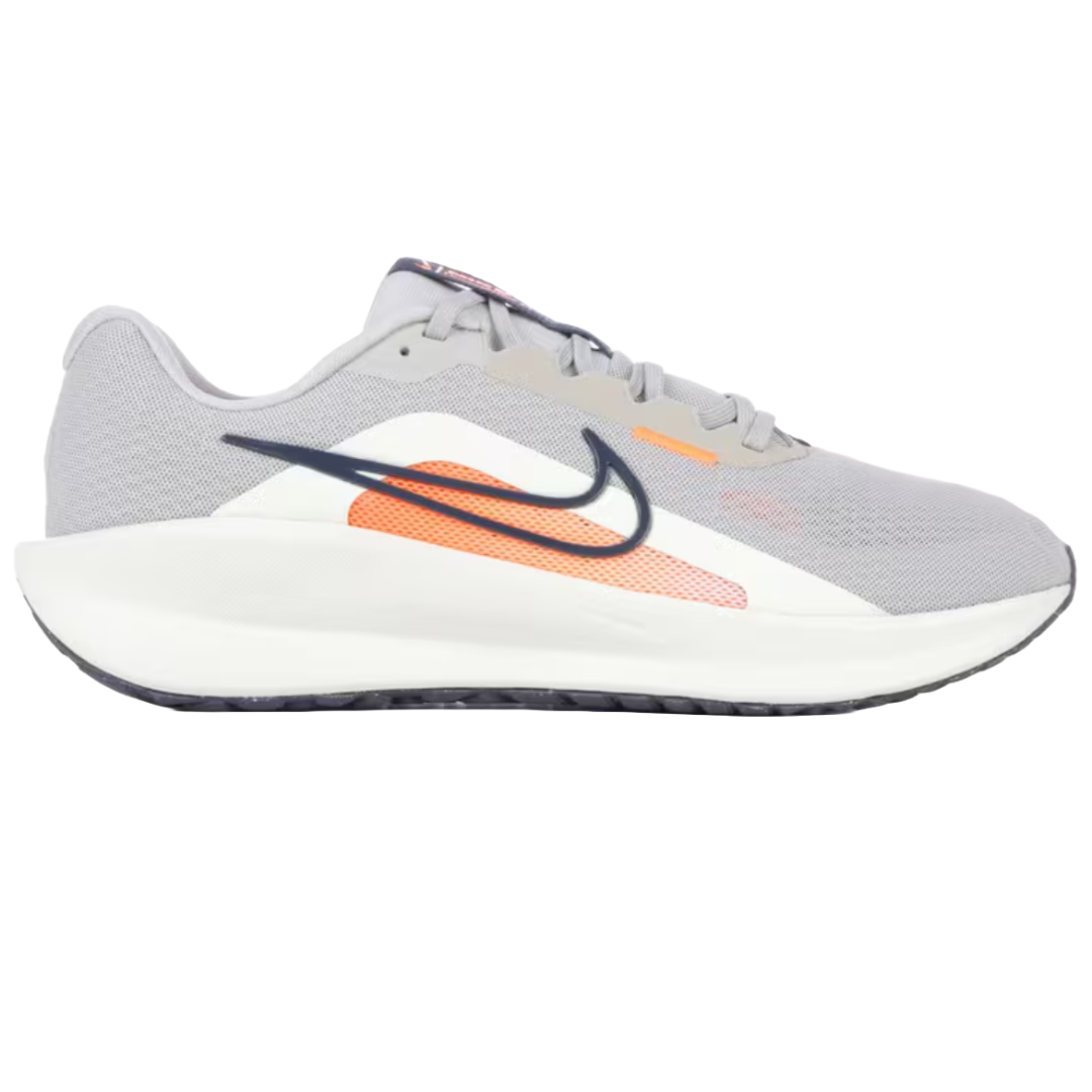 Nike Downshifter 13 Running Shoes in grey, feature a lightweight mesh upper, cushioned midsole, and an orange and black swoosh design on the side.