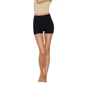 A person is wearing high-waisted black shorts paired with a beige crop top.