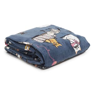 A folded plush blanket with a dark blue base featuring cartoon illustrations of cats wearing various outfits.