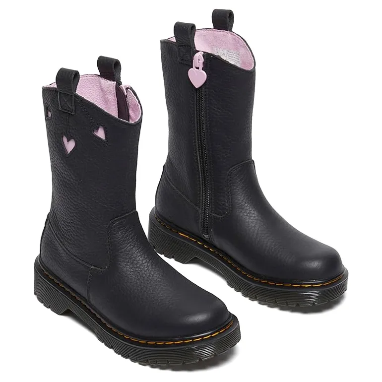 Dr. Martens Kids' Leather Boots in black feature pink heart cutouts, a side zipper with a heart pull, and a soft pink lining. They have the brand's signature yellow stitching and air-cushioned soles.