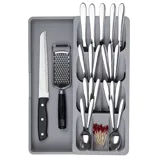 Gray cutlery organizer with sections holding knives, forks, spoons, toothpicks, a serrated knife, and a grater.