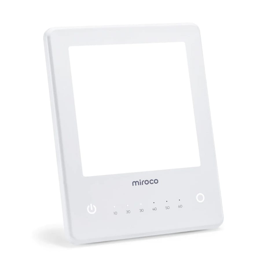 White light therapy lamp with a digital timer and intensity control buttons.
