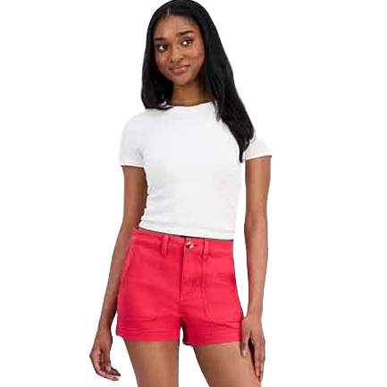 A woman is wearing a white short-sleeve t-shirt and high-waisted red shorts.