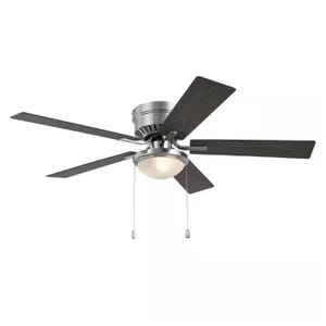 Ceiling fan with a central light fixture and four dark blades, featuring two pull chains.