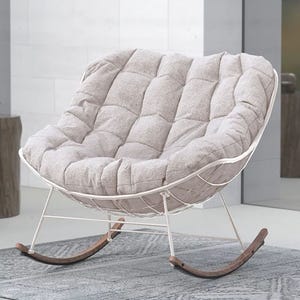 Outdoor steel rocker featuring a curved design with a light beige cushion, seated on a metal frame with wooden rocking legs, ideal for comfortable lounging.
