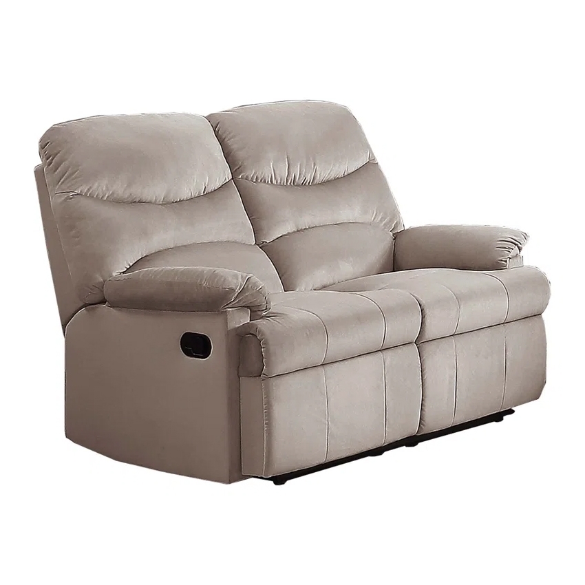 A beige, two-seater reclining loveseat with plush cushions and a manual lever on the side for reclining.