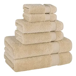 A stack of beige towels in various sizes, including two small towels on top, two medium-sized towels in the middle, and three larger towels at the bottom, all featuring a decorative band.